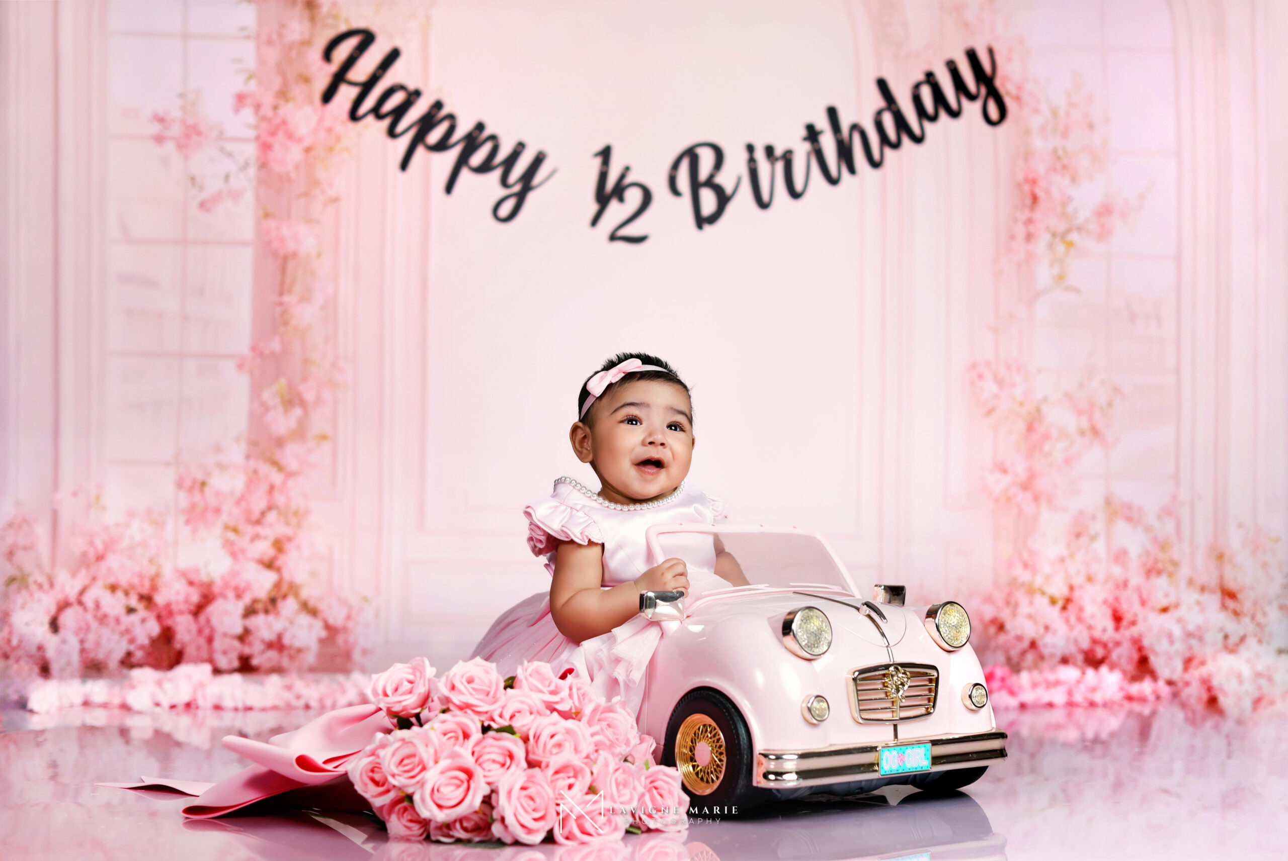 6 months baby girl studio photoshoot showing a sweet baby girl in a professional studio with soft lighting and elegant styling.