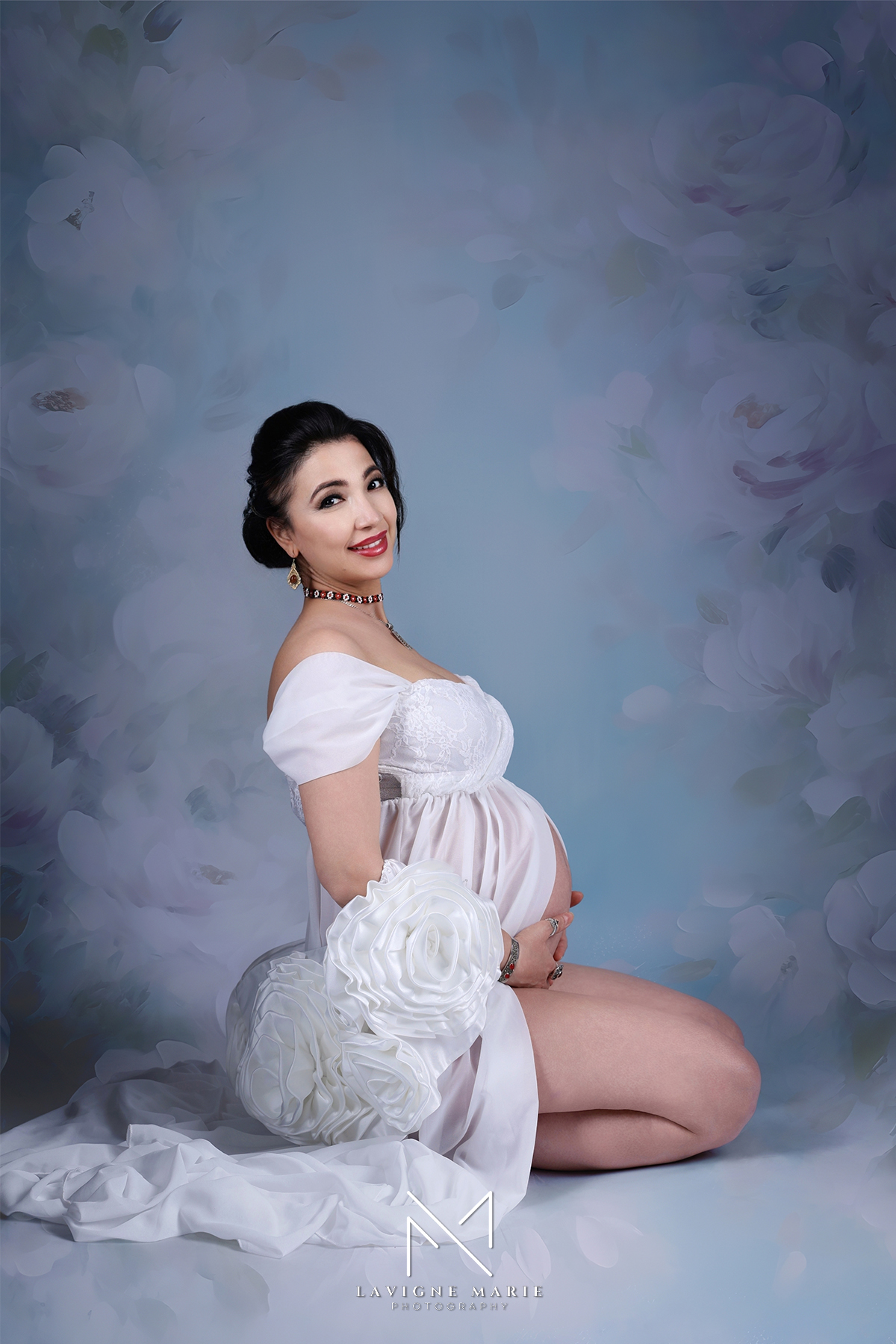 Boudoir maternity studio session showcasing elegant, intimate portraits of a pregnant woman in a softly lit studio.