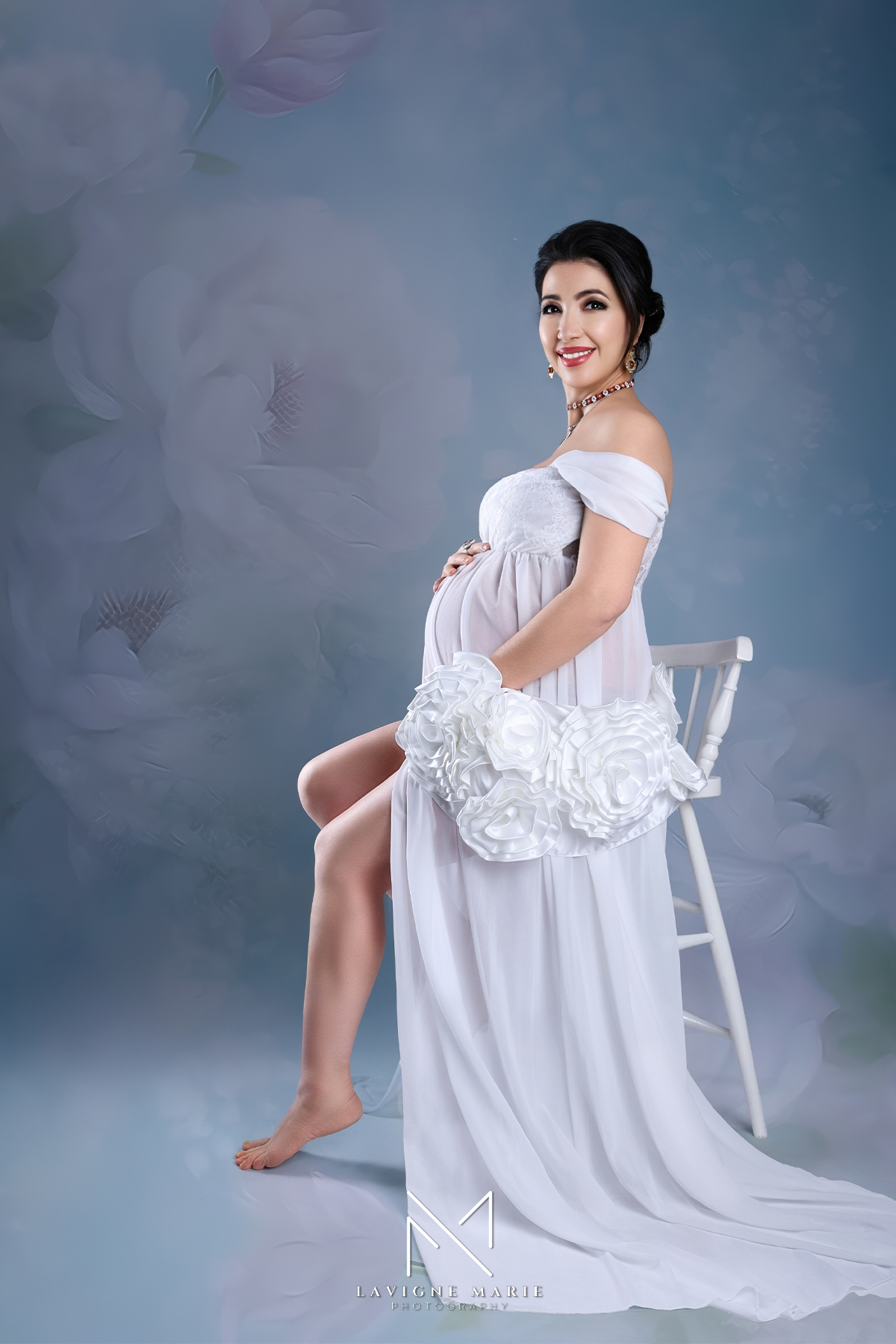 Boudoir maternity photoshoot in London featuring sensual and elegant pregnancy portraits in a professional studio.