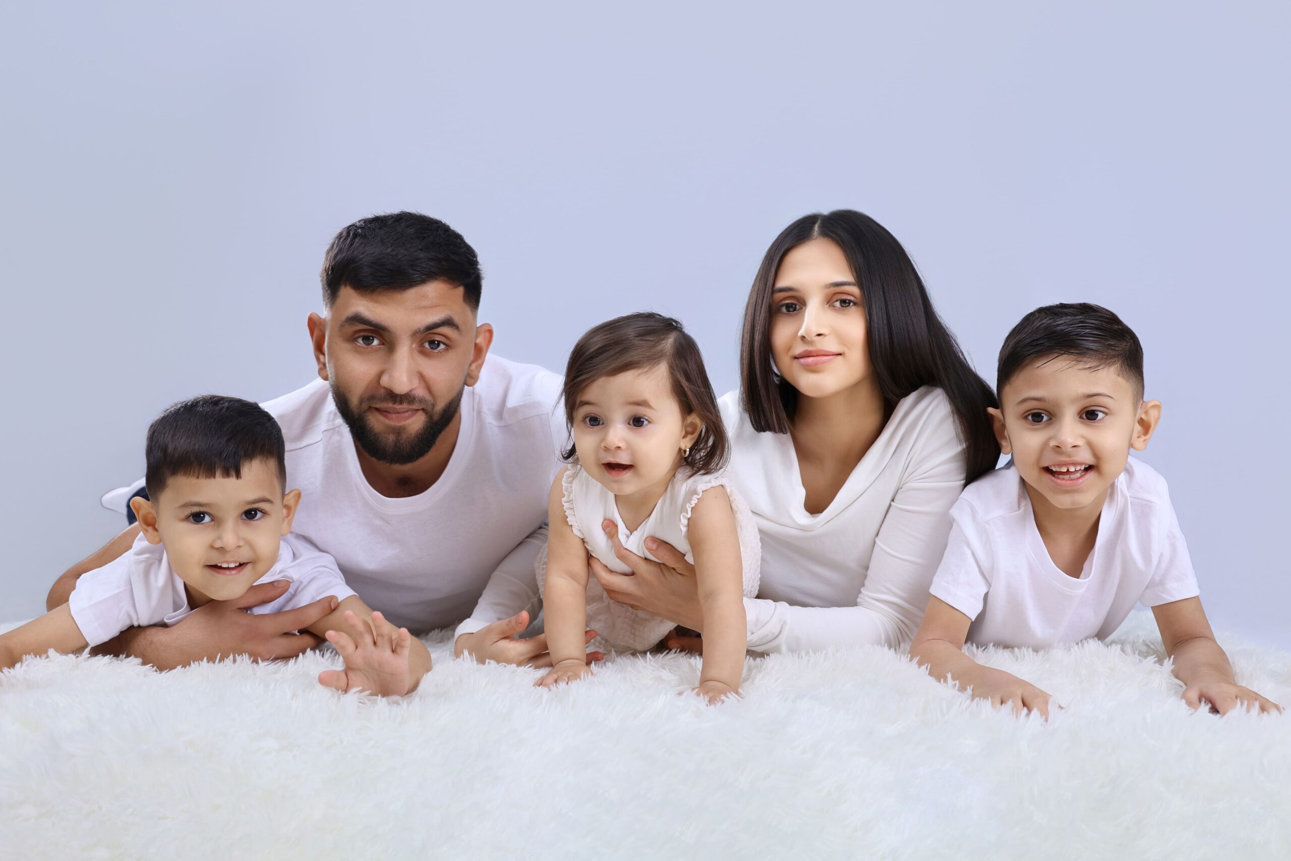 Happy family posing together during a professional family photography session in London.