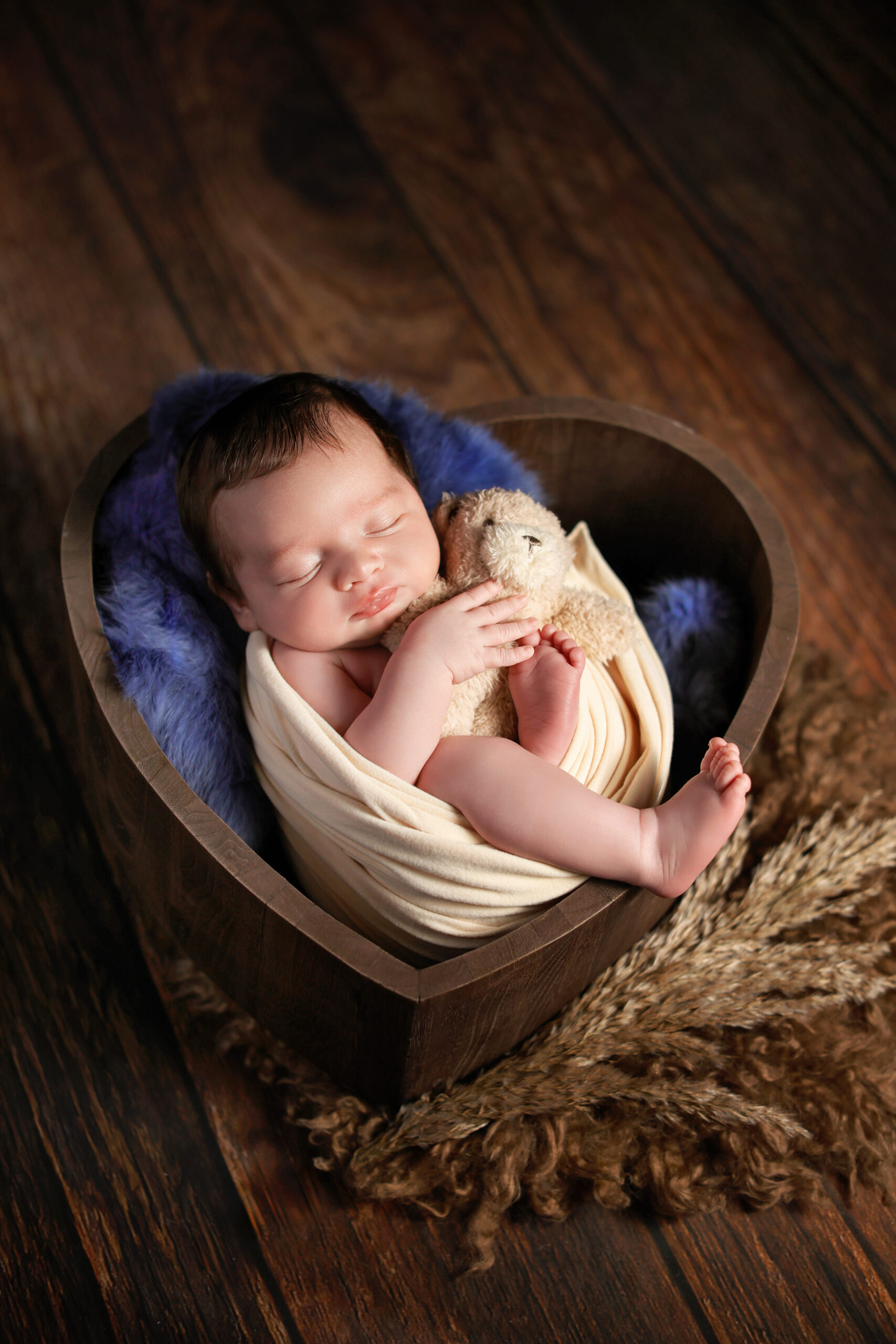 Newborn photography featuring natural baby portraits with gentle posing, soft textures, and a peaceful studio atmosphere