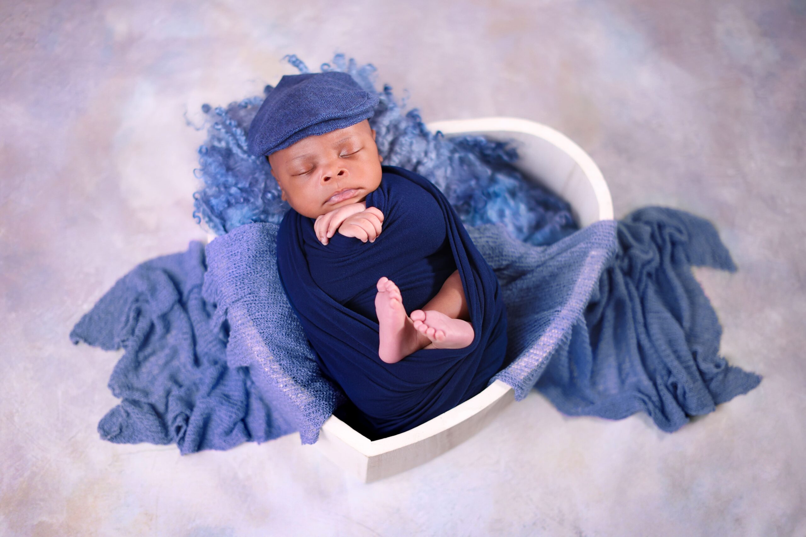 Sleeping newborn baby photographed during a professional newborn photography session in London.