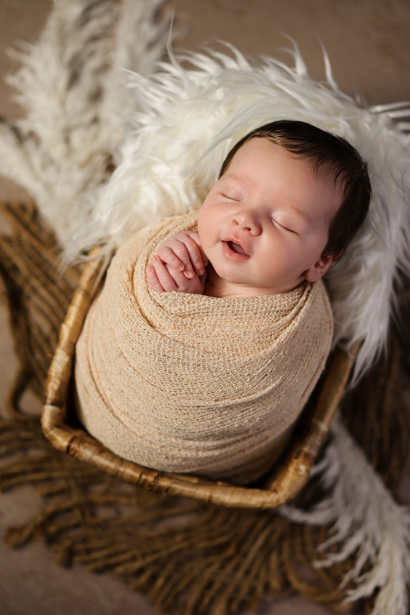 Professional newborn photos with a natural look showing a relaxed baby portrait captured with soft light and organic styling