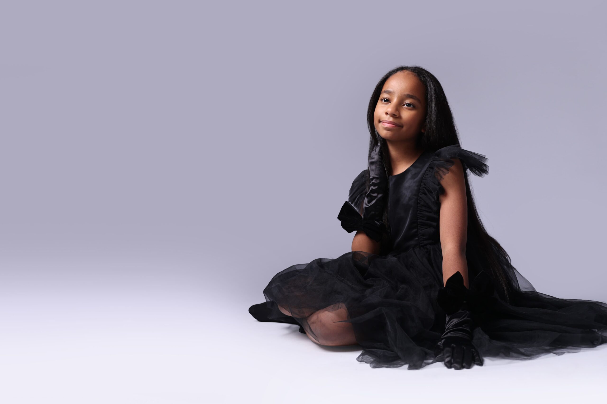 Children enjoying a birthday photoshoot with spotlight in professional photography studio