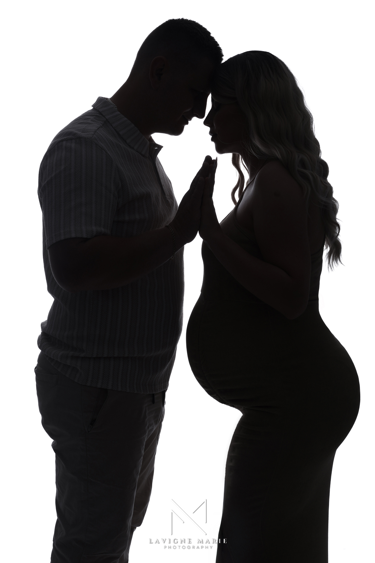Elegant silhouette family couple photoshoot in a professional London photography studio, capturing timeless love and connection in a minimalist black and white style