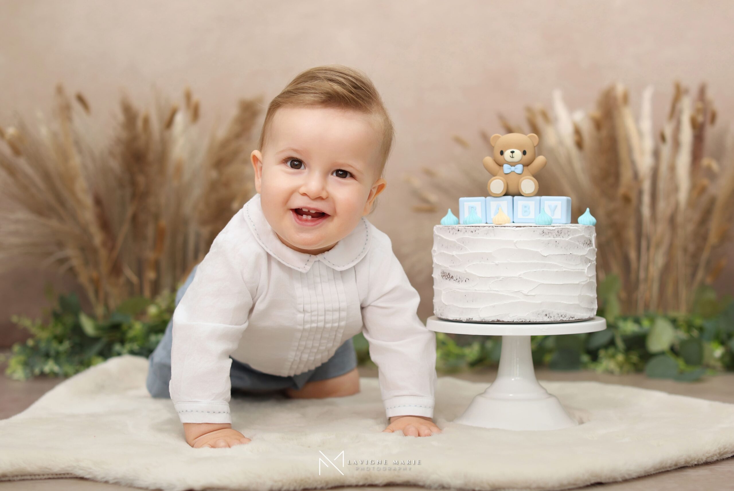 Smash the cake children photoshoot with a young child enjoying a playful birthday session in a professional studio