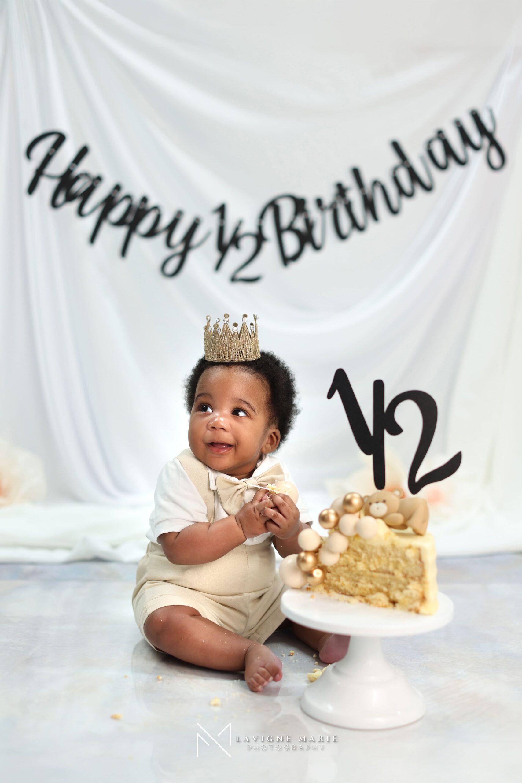 Happy baby celebrating half birthday photoshoot with themed props and soft studio setup