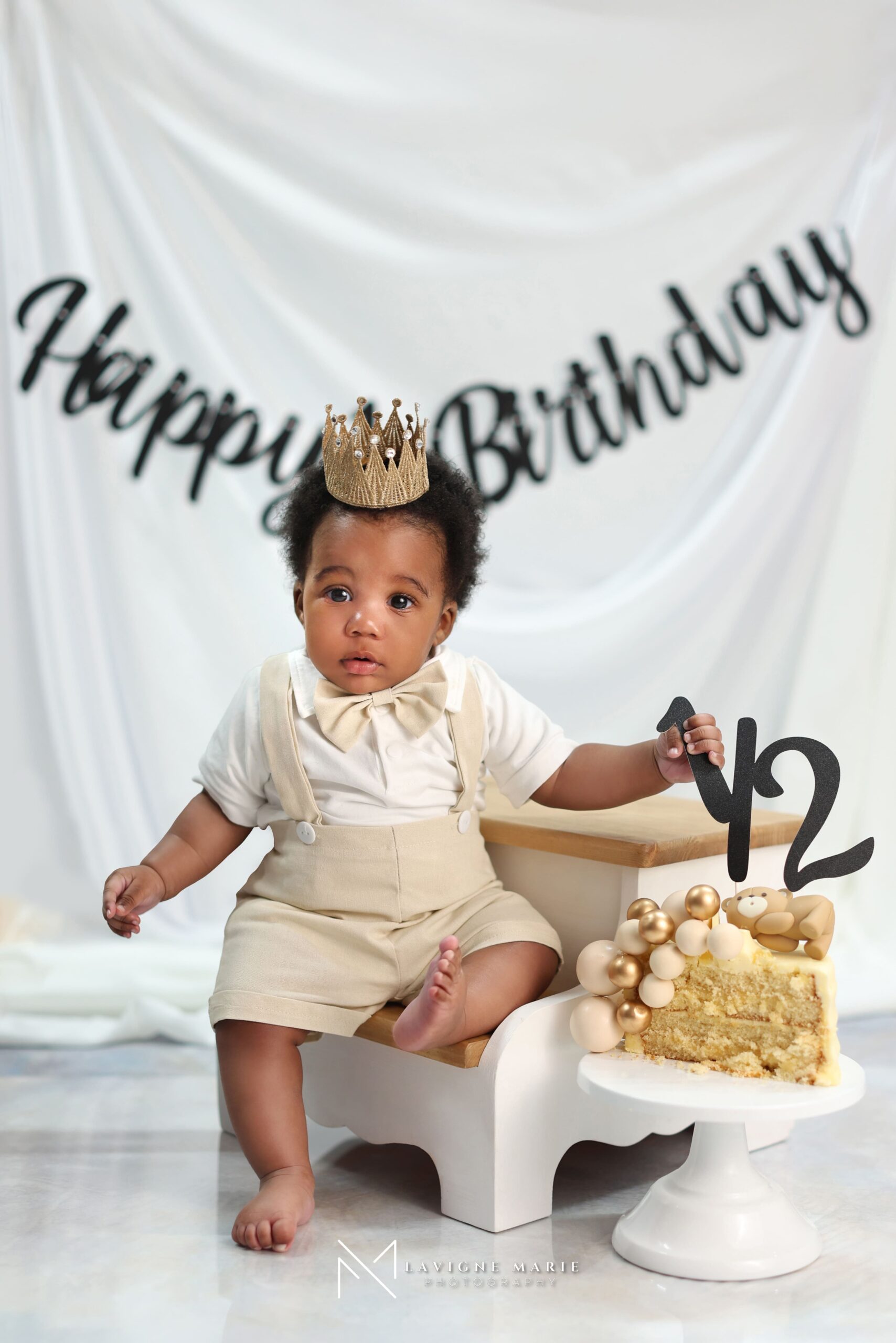 Six-month-old baby posing during a professional studio photoshoot with gentle lighting and neutral background