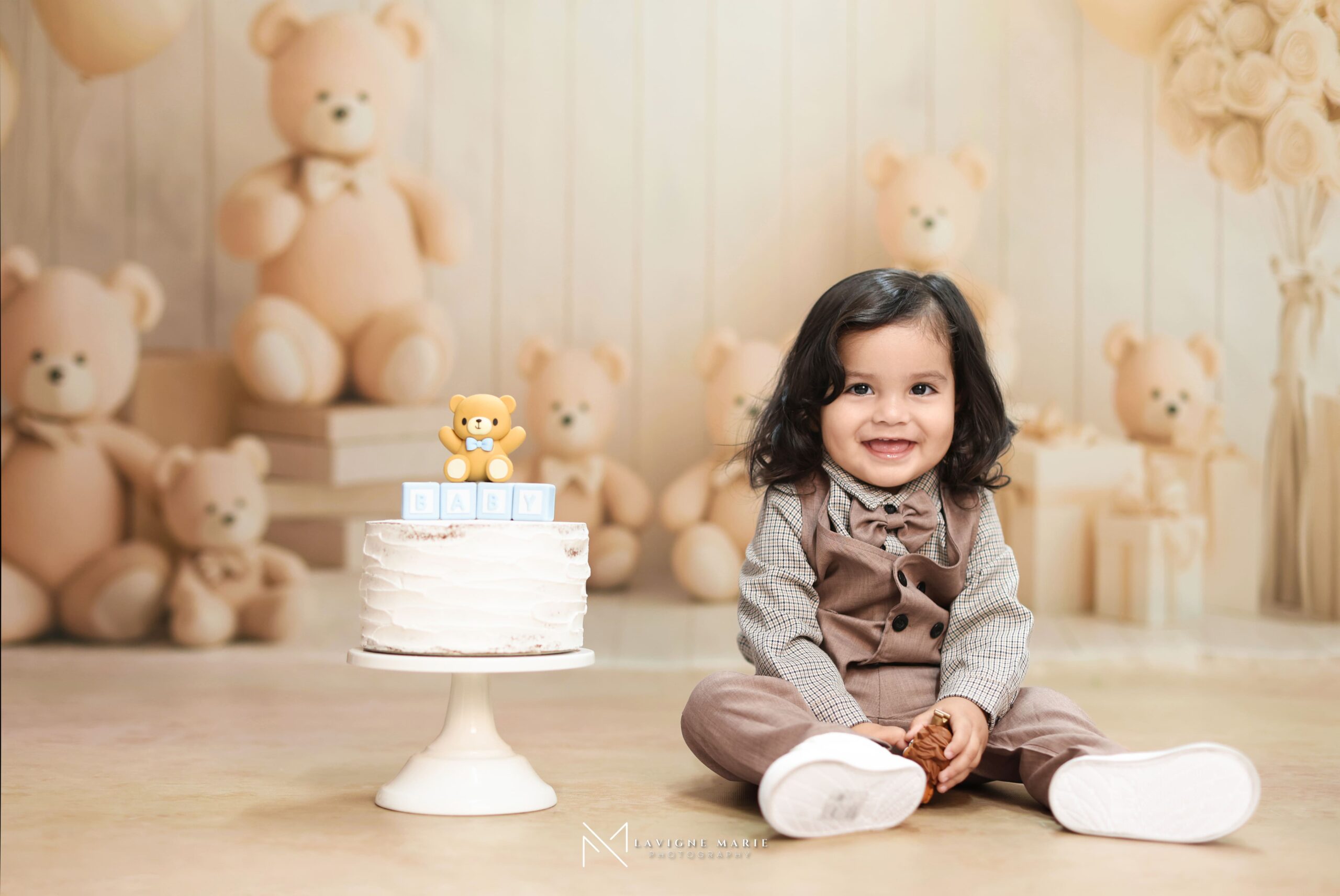 Two-year-old toddler enjoying a birthday photoshoot with themed decorations and cheerful expressions