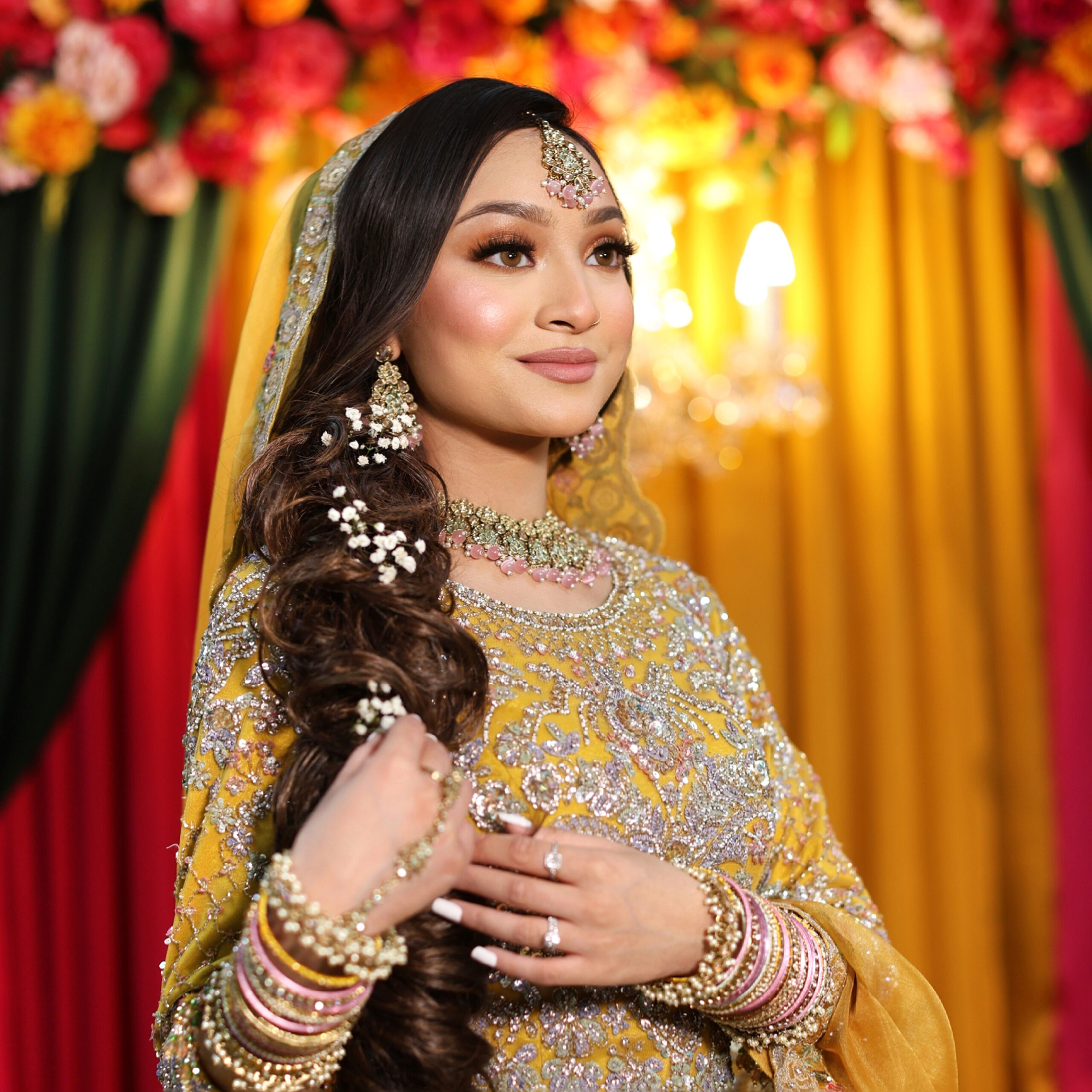Mehndi bride with intricate henna designs smiling during pre wedding celebration captured by female photographer in London