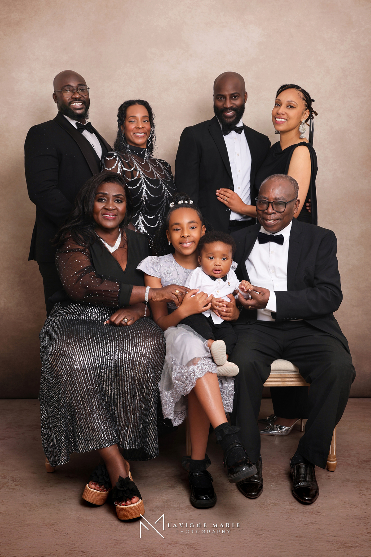 Family studio portrait with vintage cream backdrop featuring elegant fine art family photography and soft timeless studio lighting in London.