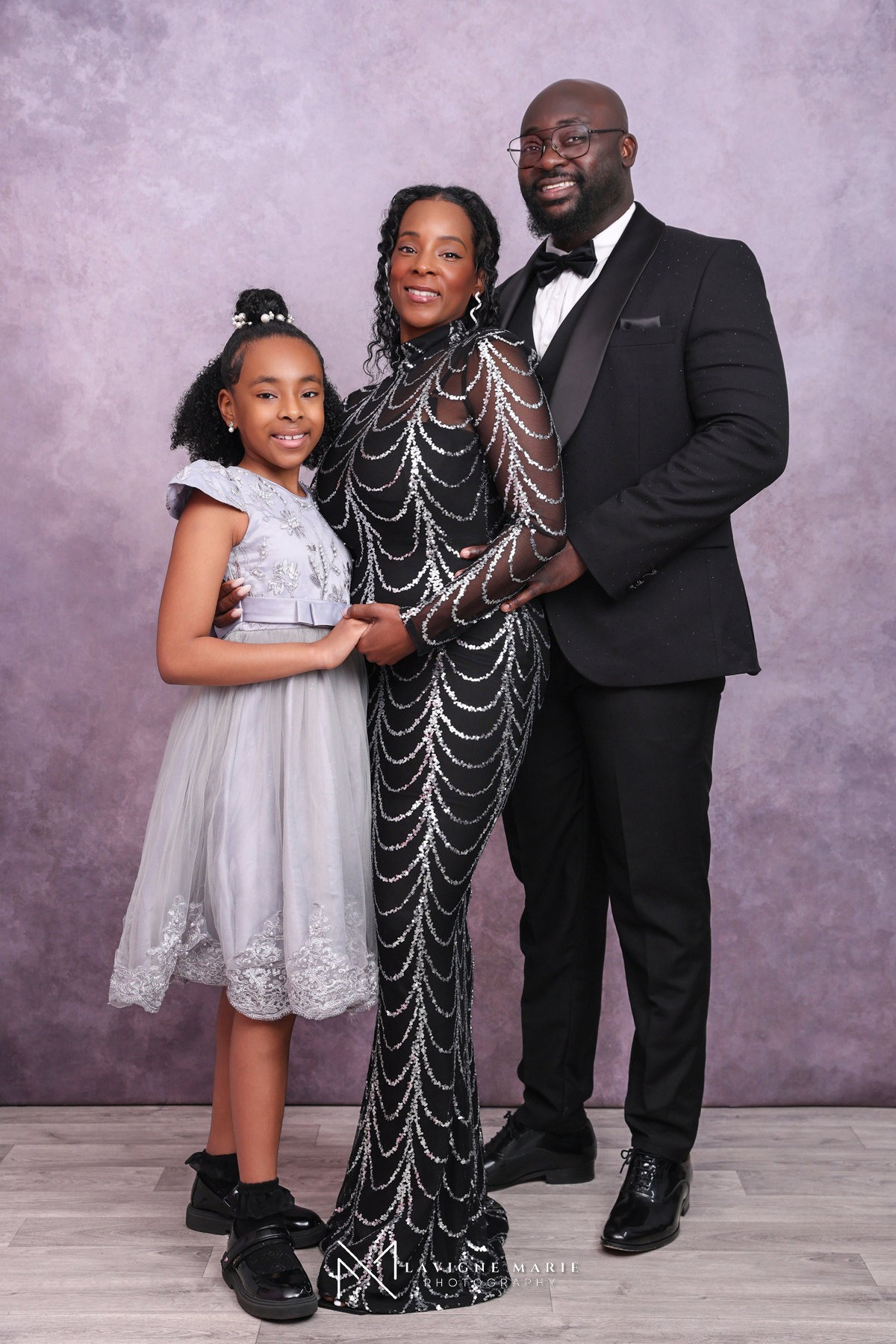 Family studio photoshoot with vintage purple backdrop featuring elegant family portrait photography and timeless fine art studio lighting in London.