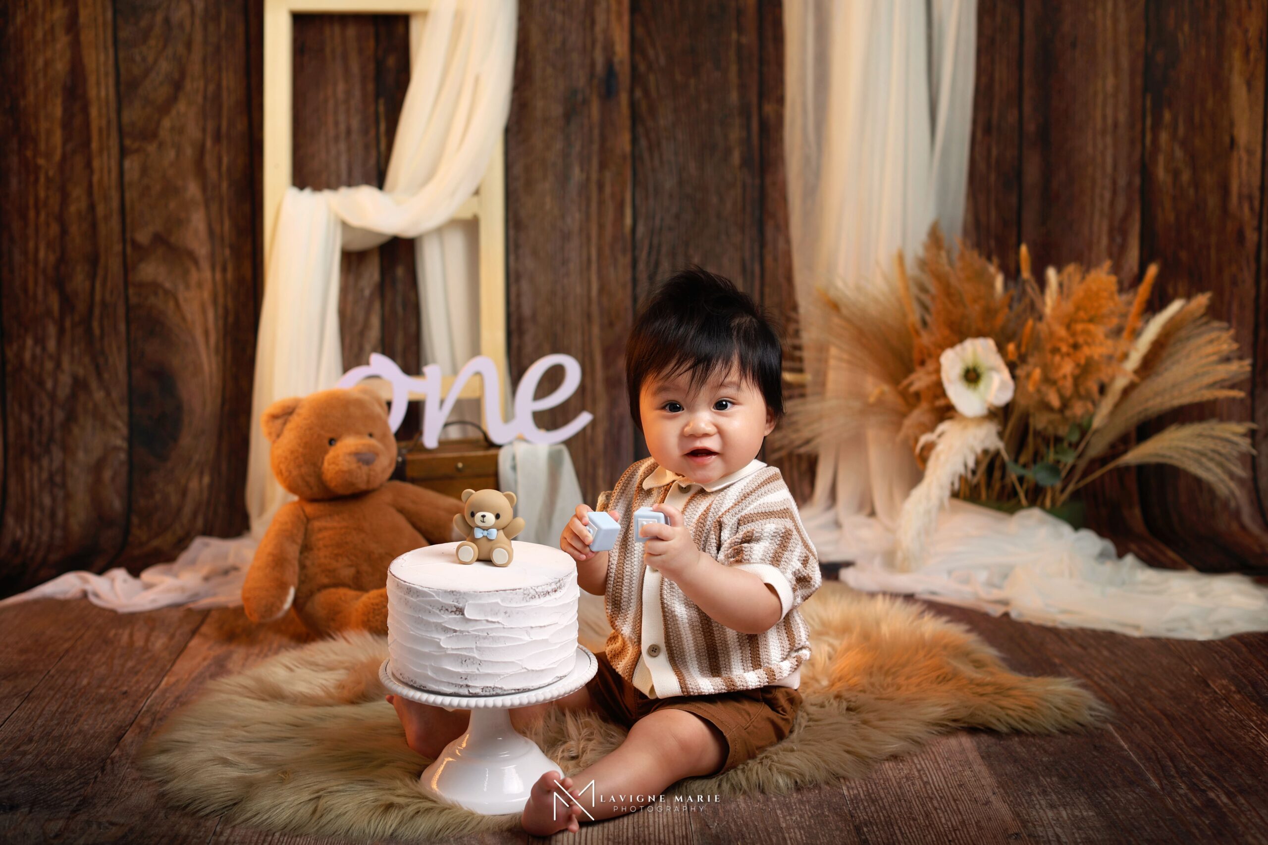 First birthday photoshoot in London with a boho style setup featuring a baby milestone portrait in a soft, natural studio theme.
