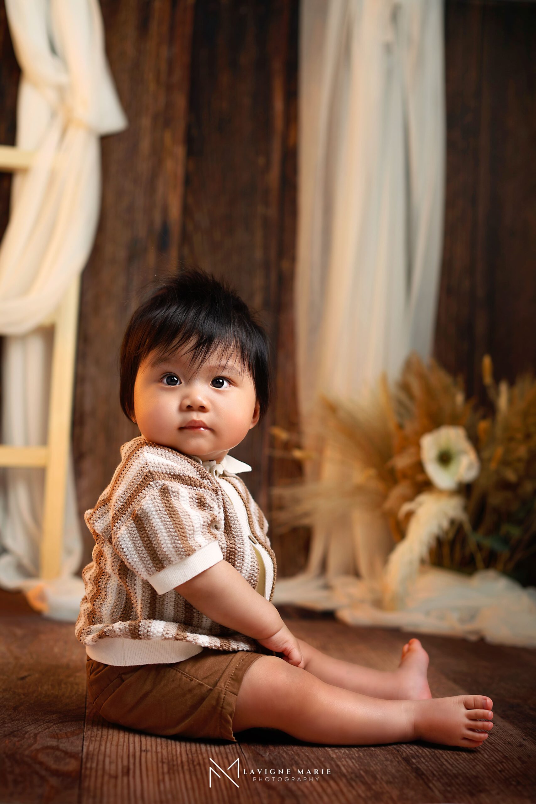 First birthday photoshoot in London by Lavigne Marie Photography featuring a baby’s milestone portrait in a professional studio setting.
