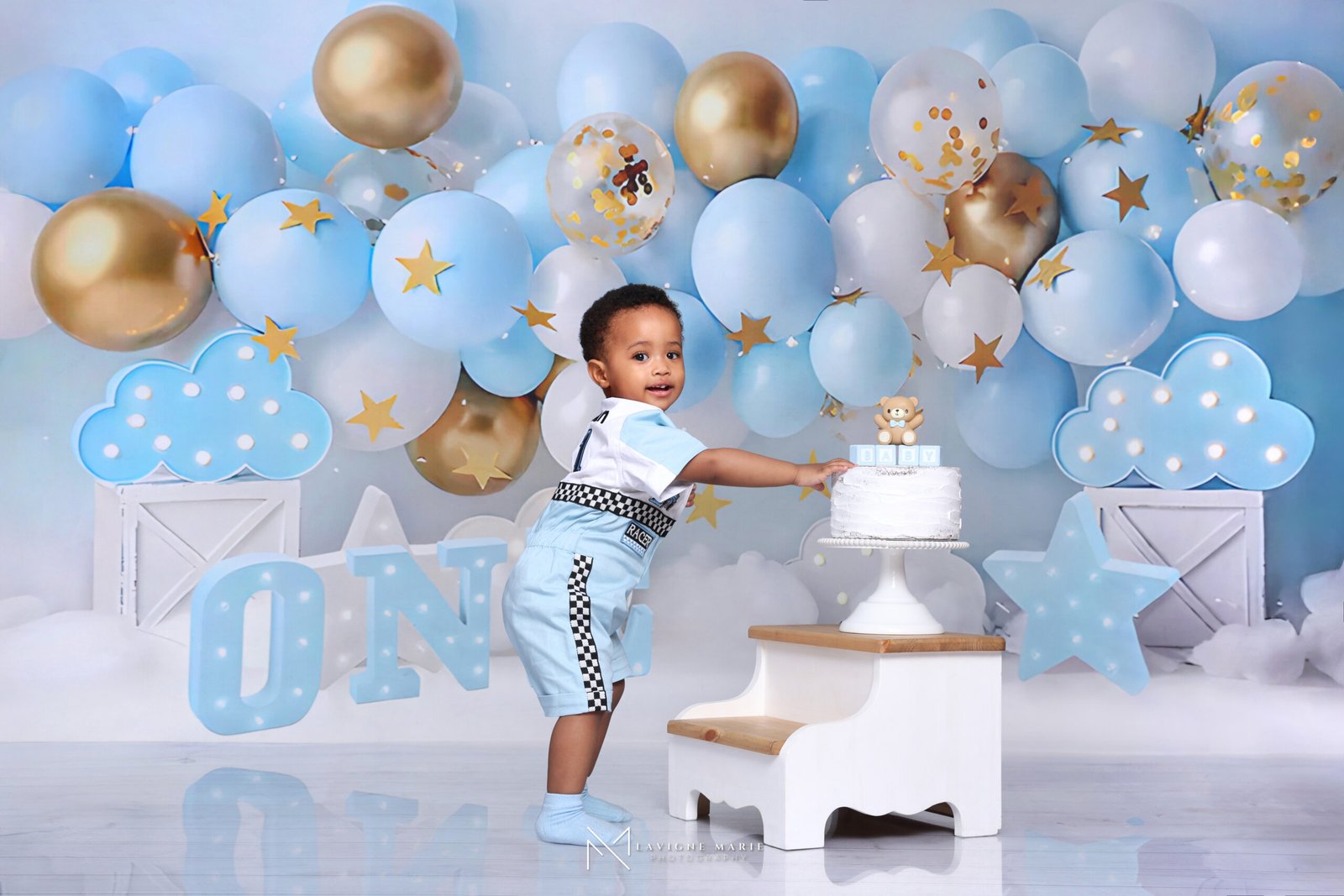 Baby boy first birthday portrait with birthday decorations by Lavigne Marie Photography