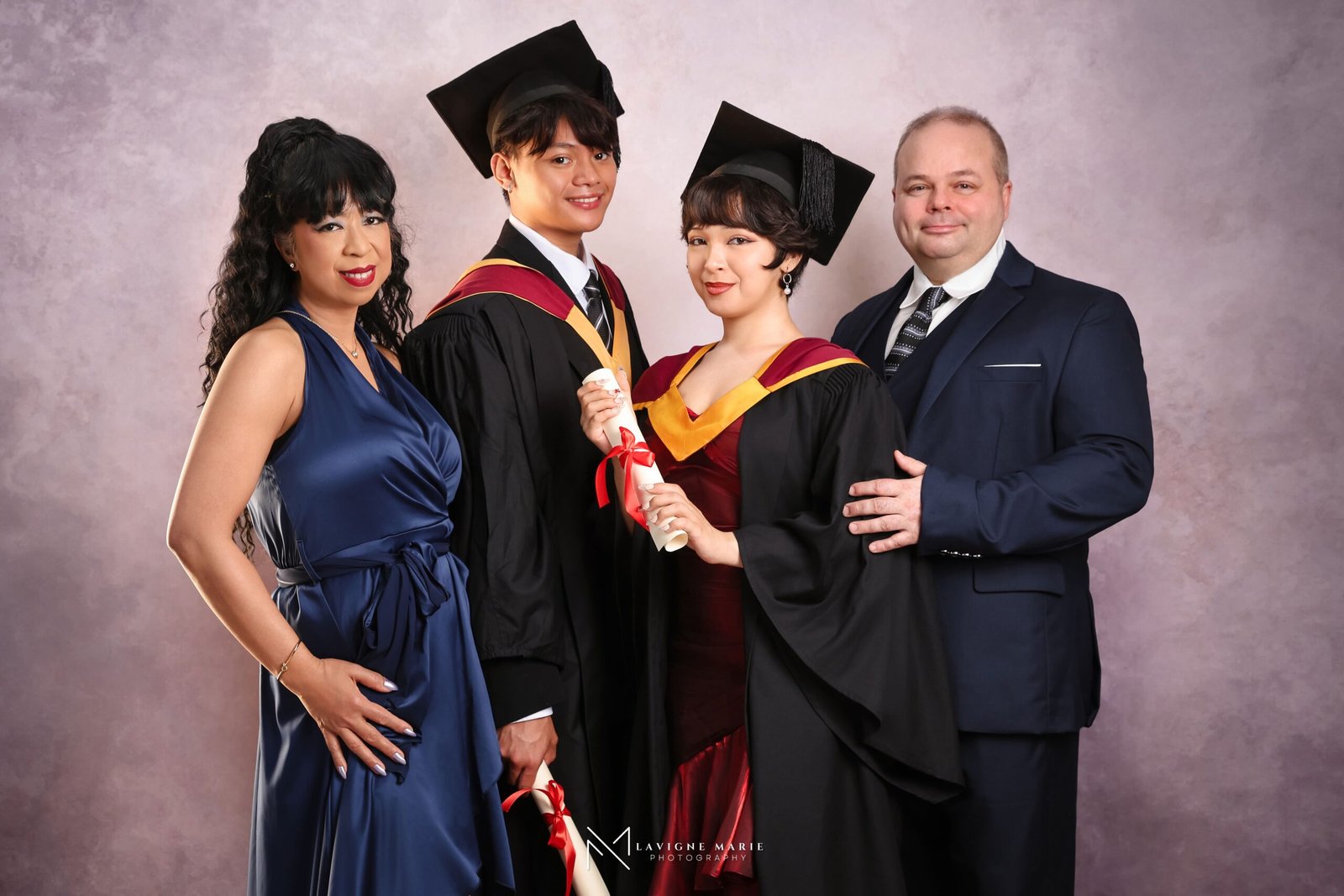 Graduation family studio session in London with graduate and family members celebrating together in a professional photography studio